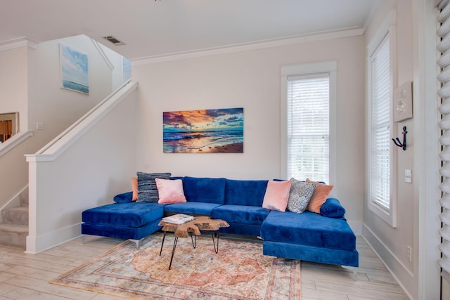 living room featuring crown molding and light wood-type flooring