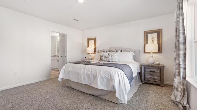 carpeted bedroom featuring connected bathroom