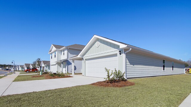 view of side of home with a garage and a lawn