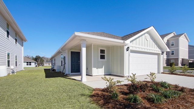 view of front of house with a front yard and a garage