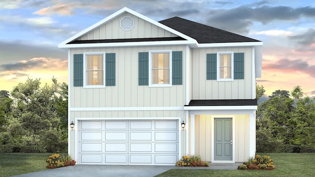 view of front of house featuring a yard and a garage