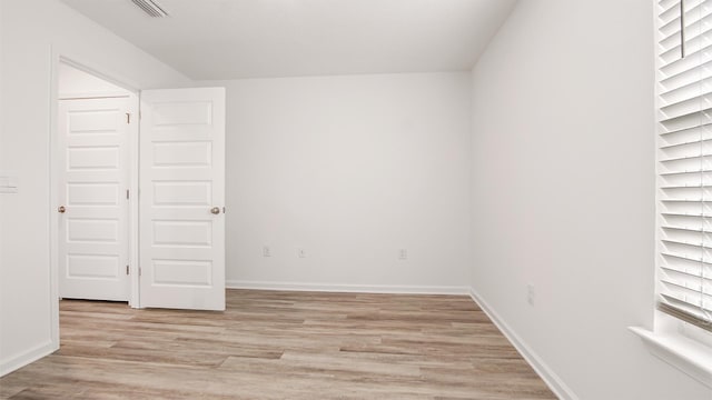 unfurnished room with light wood-type flooring