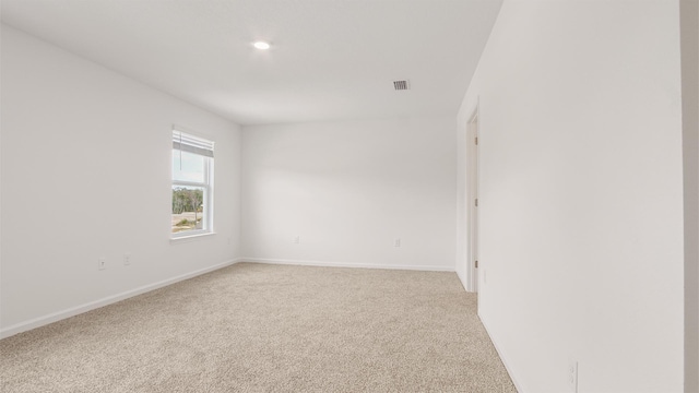 spare room with light colored carpet