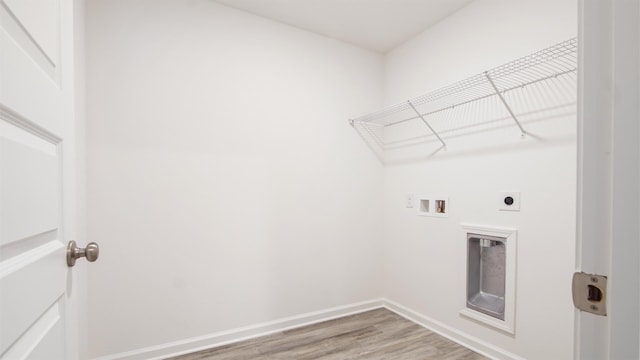 washroom featuring washer hookup, hookup for an electric dryer, and hardwood / wood-style flooring