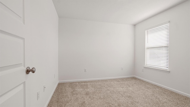 carpeted spare room featuring a healthy amount of sunlight