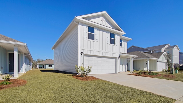 view of front of property featuring a front lawn and a garage