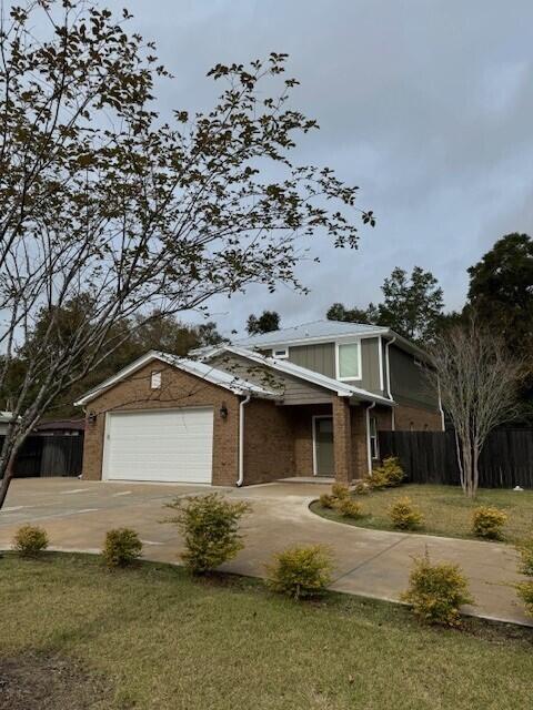 view of front facade with a garage and a front lawn