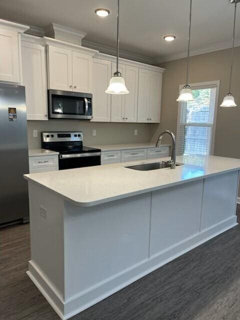 kitchen with white cabinets, a center island with sink, stainless steel appliances, and hanging light fixtures