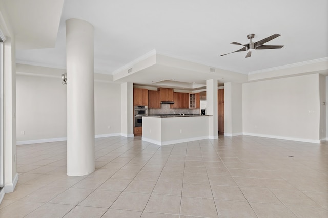 unfurnished living room featuring ceiling fan, light tile patterned floors, ornamental molding, and a tray ceiling