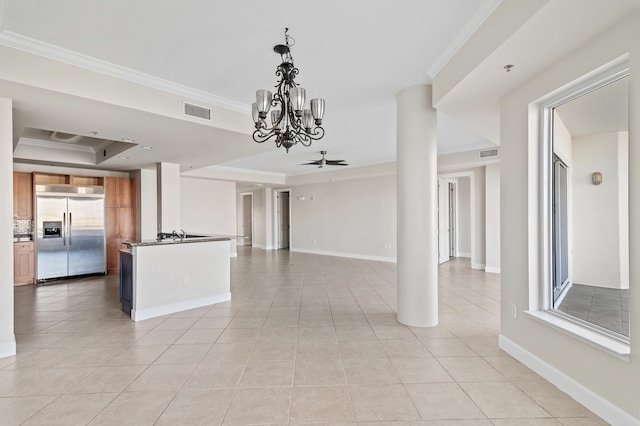 interior space with a raised ceiling, stainless steel built in fridge, light tile patterned flooring, ceiling fan with notable chandelier, and ornamental molding