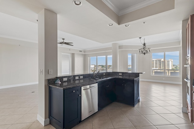 kitchen with dark stone countertops, plenty of natural light, stainless steel dishwasher, and sink