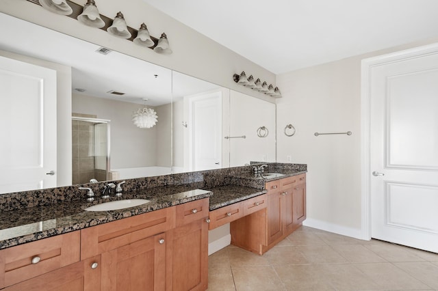 bathroom with tile patterned floors, vanity, and a shower with shower door