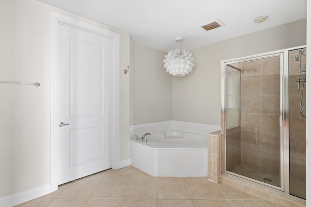 bathroom featuring tile patterned floors and independent shower and bath