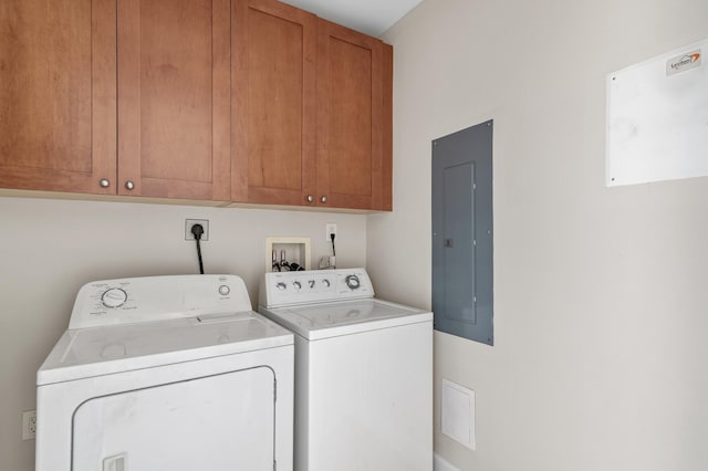 clothes washing area featuring cabinets, independent washer and dryer, and electric panel