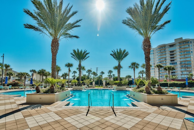 view of swimming pool featuring pool water feature and a patio