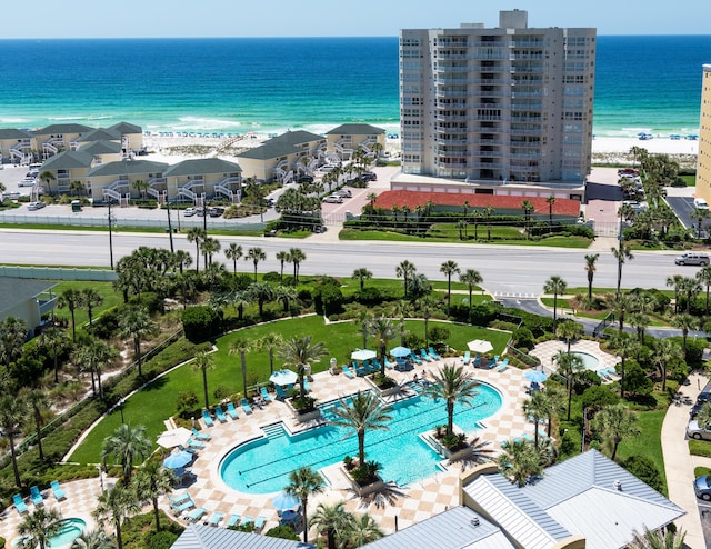 bird's eye view with a water view and a beach view