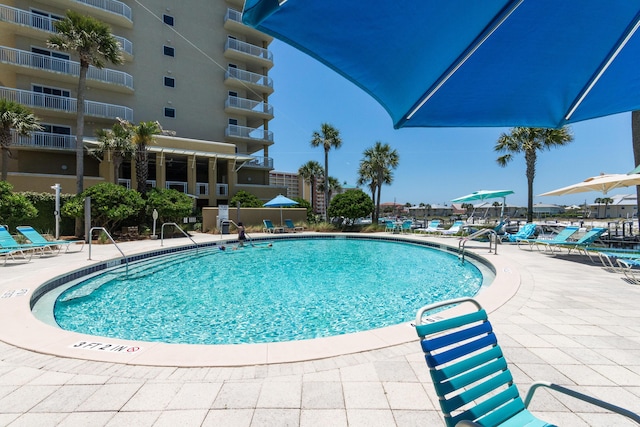 view of swimming pool with a patio