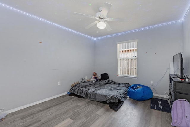 bedroom with ceiling fan and hardwood / wood-style flooring