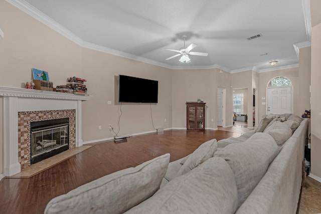 664 Brunson St, Crestview, FL 32536 - living area with ceiling fan, wood finished floors, ornamental molding, and a tiled fireplace
