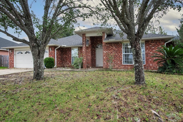 ranch-style home with a garage and a front lawn