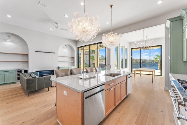 kitchen with a center island with sink, a healthy amount of sunlight, sink, and stainless steel appliances