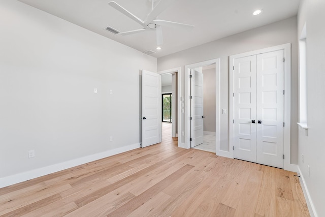 unfurnished bedroom with connected bathroom, ceiling fan, a closet, and light hardwood / wood-style floors