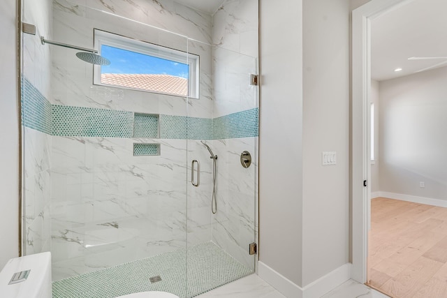 bathroom featuring wood-type flooring and a shower with door