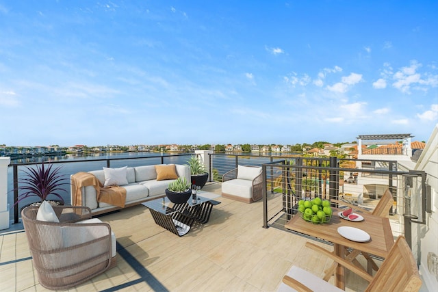 view of patio featuring outdoor lounge area, a water view, and a balcony