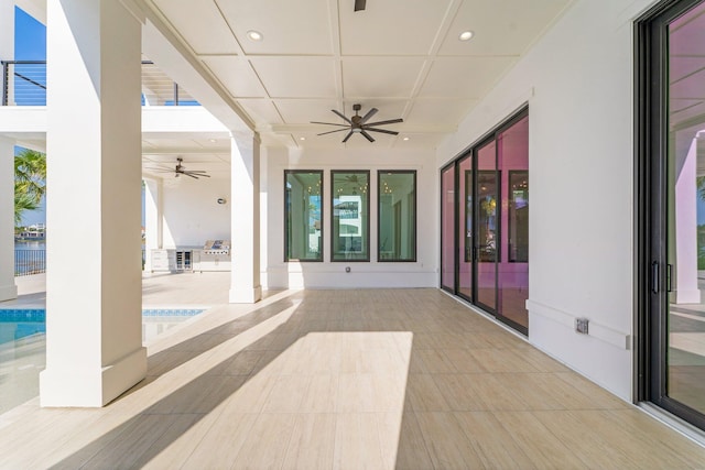 view of patio / terrace featuring ceiling fan and a swimming pool