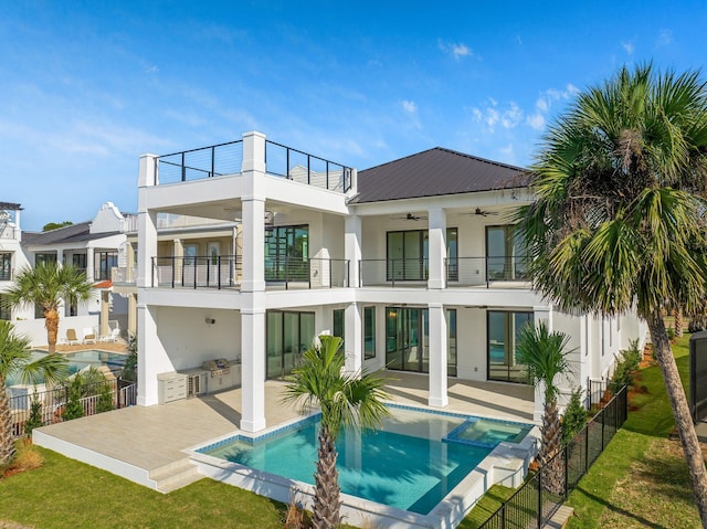 rear view of house featuring a balcony, area for grilling, ceiling fan, a patio, and a fenced in pool