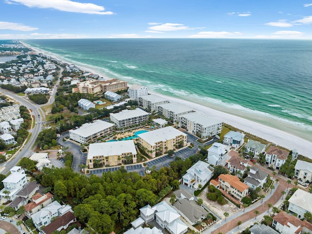 drone / aerial view featuring a water view and a beach view