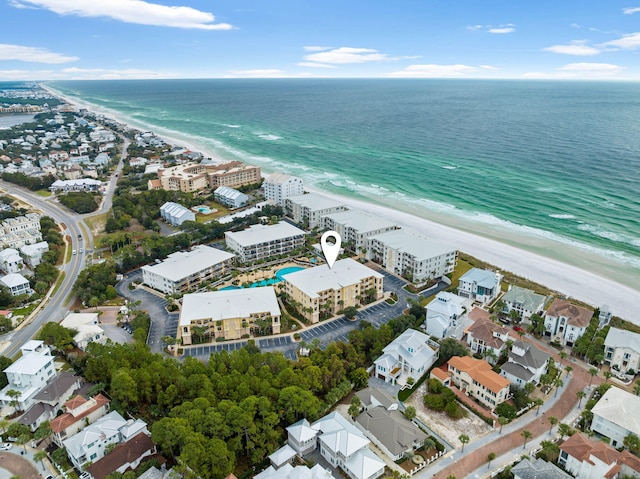 bird's eye view featuring a water view and a beach view