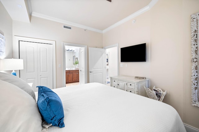 bedroom featuring connected bathroom, a closet, and ornamental molding