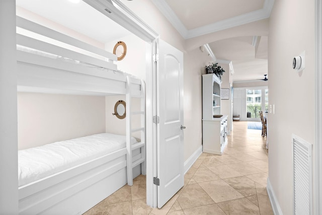 tiled bedroom featuring crown molding