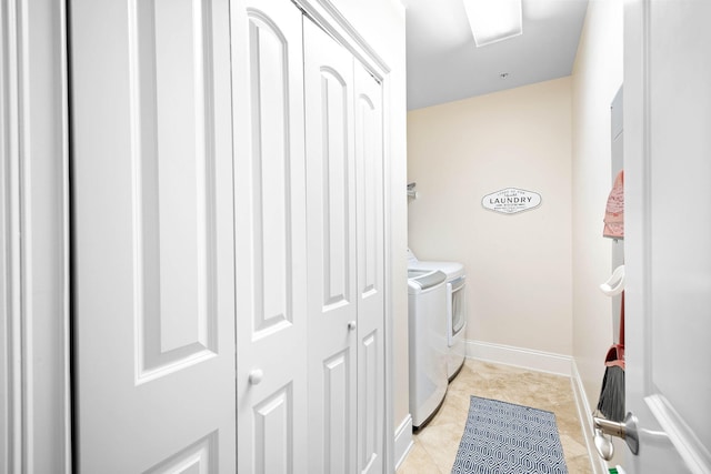 laundry area with light tile patterned floors and independent washer and dryer