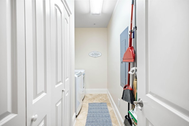 laundry area with separate washer and dryer and light tile patterned floors