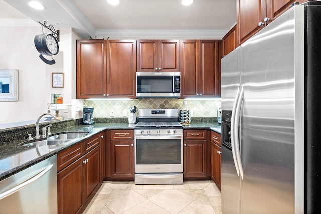 kitchen featuring dark stone counters, sink, tasteful backsplash, light tile patterned flooring, and stainless steel appliances