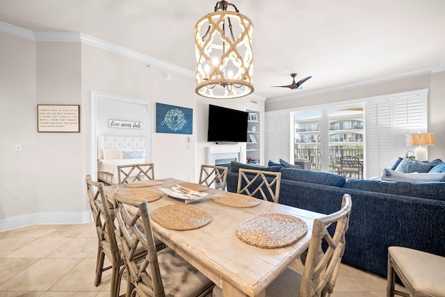 dining space featuring light tile patterned floors, ceiling fan with notable chandelier, and ornamental molding