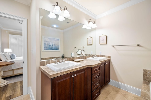 bathroom with tile patterned floors, vanity, and crown molding