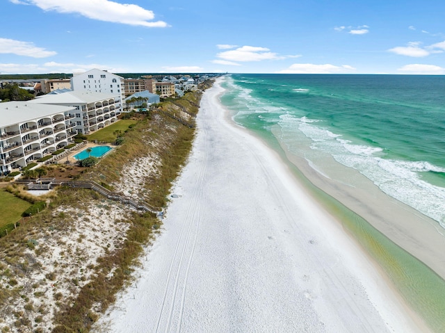 birds eye view of property with a water view and a view of the beach