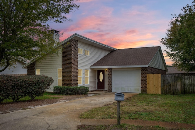 view of front of property featuring a yard and a garage