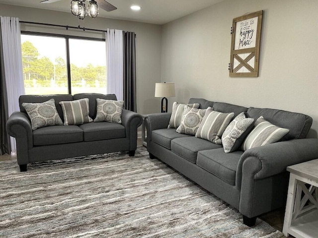 carpeted living room featuring ceiling fan