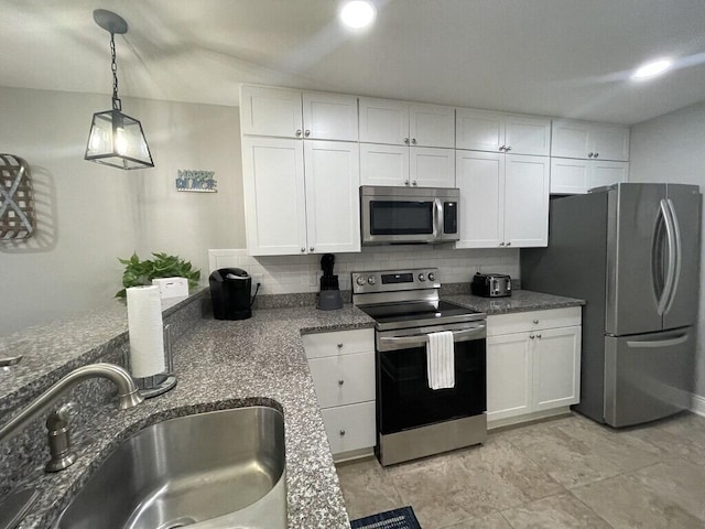 kitchen featuring sink, hanging light fixtures, decorative backsplash, white cabinetry, and stainless steel appliances