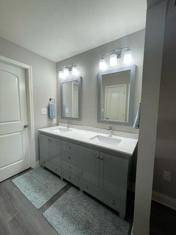 bathroom with vanity and hardwood / wood-style flooring