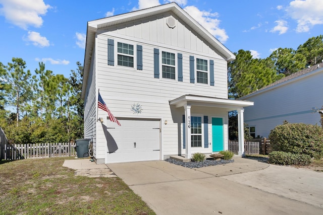 view of property with a porch and a garage