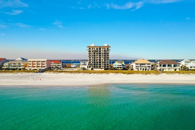 drone / aerial view with a water view and a view of the beach