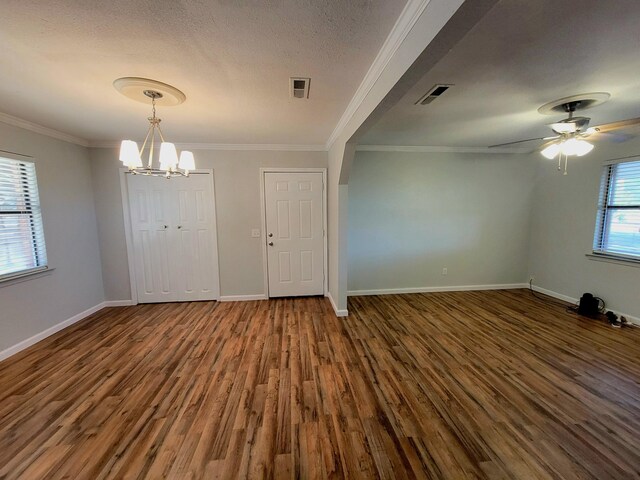 interior space with crown molding, ceiling fan with notable chandelier, and dark hardwood / wood-style floors