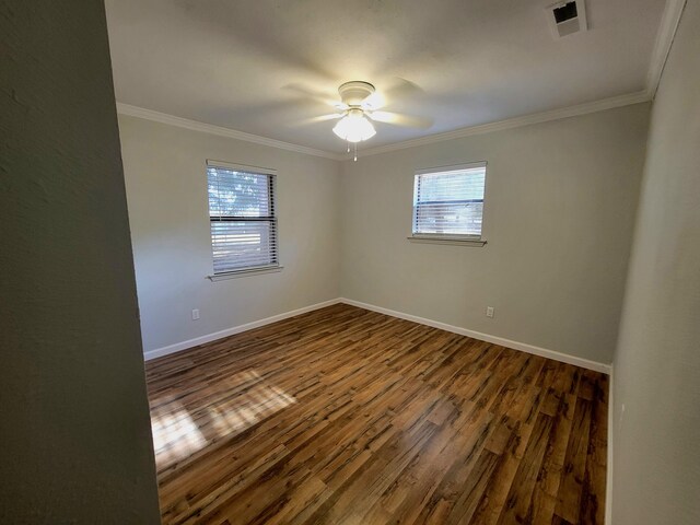 unfurnished room with ceiling fan, dark hardwood / wood-style flooring, and crown molding