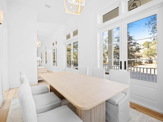 dining room with light hardwood / wood-style flooring and a healthy amount of sunlight