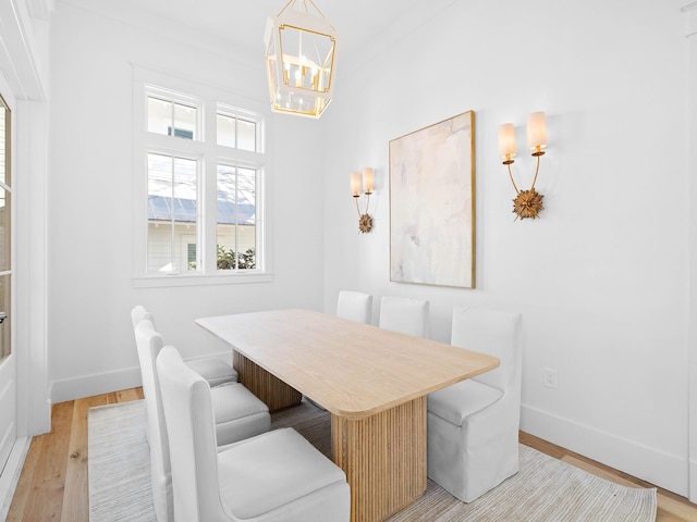 dining room with a chandelier and light hardwood / wood-style floors